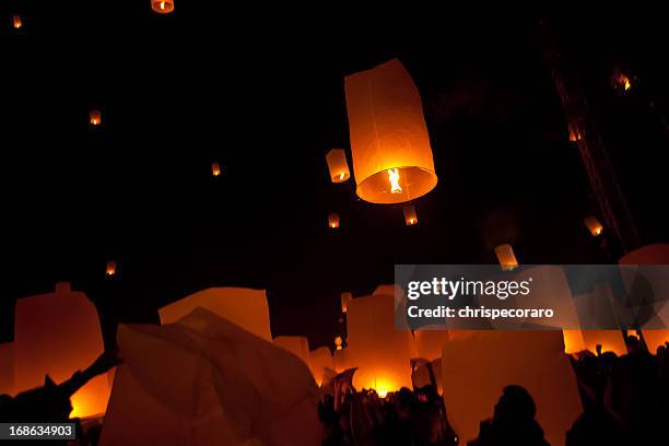 silhouettes of people and dim lighting at loi krathong - thailand illumination festival bildbanksfoton och bilder