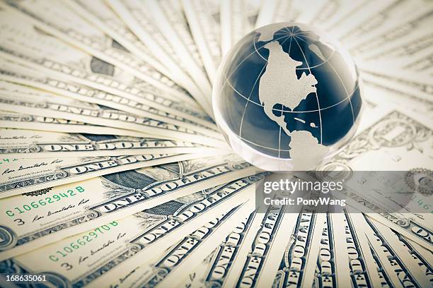 glass globe and money - us currency stockfoto's en -beelden