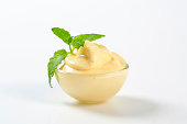Vanilla cream in a bowl garnished by mint leaf