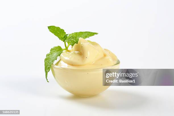 vanilla cream in a bowl garnished by mint leaf - vanilla ice cream stock pictures, royalty-free photos & images