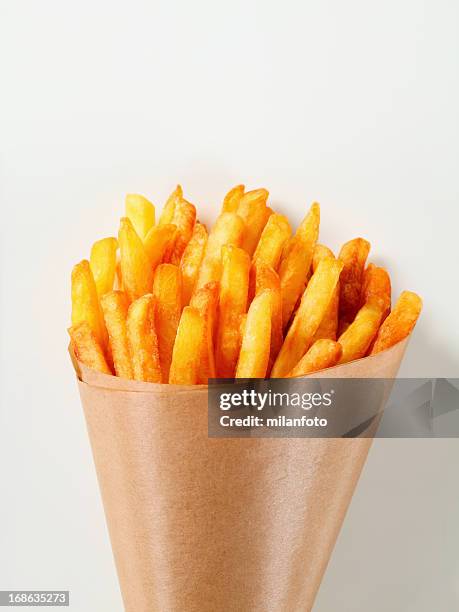 french fries in a paper cone - cone french fries stock pictures, royalty-free photos & images