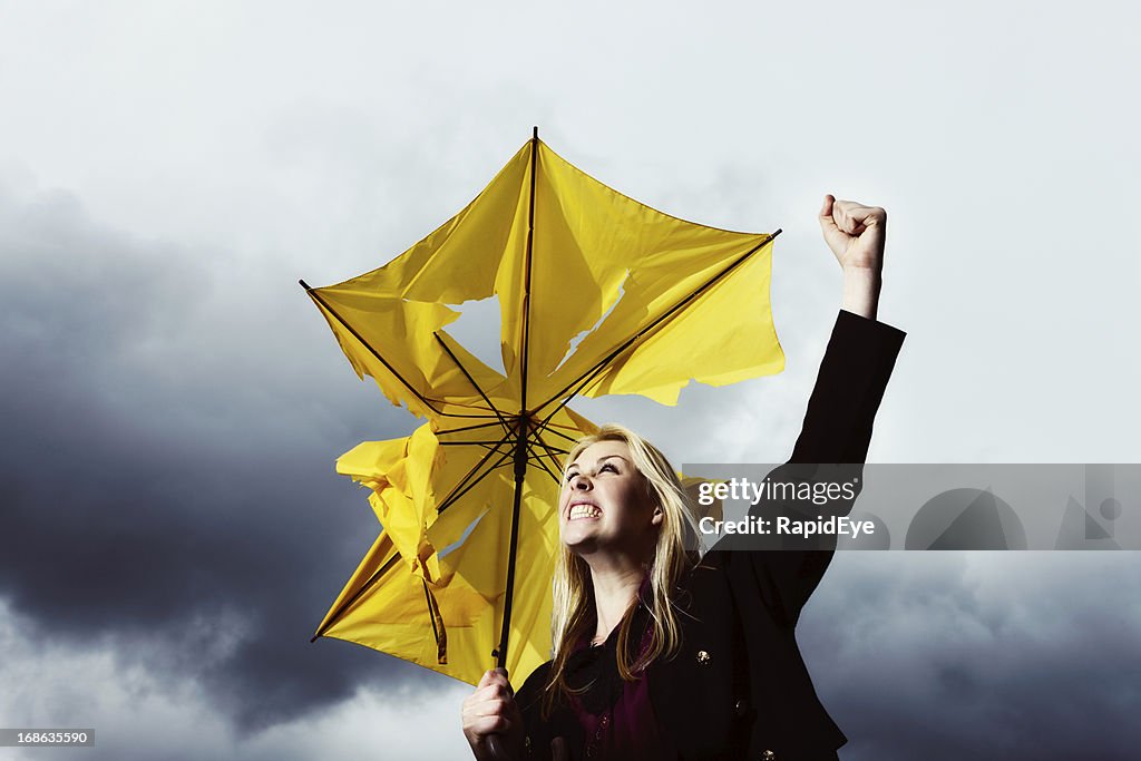 That's enough! Blonde with ruined umbrella shakes fist at thunderstorm