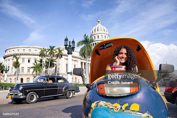 cuban girl in coco-taxi infront of capitolio building, havana, cuba - capitolio stockfoto's en -beelden