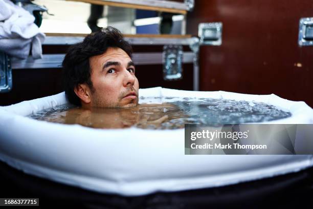 Sergio Perez of Mexico and Oracle Red Bull Racing takes an ice bath prior to the F1 Grand Prix of Singapore at Marina Bay Street Circuit on September...