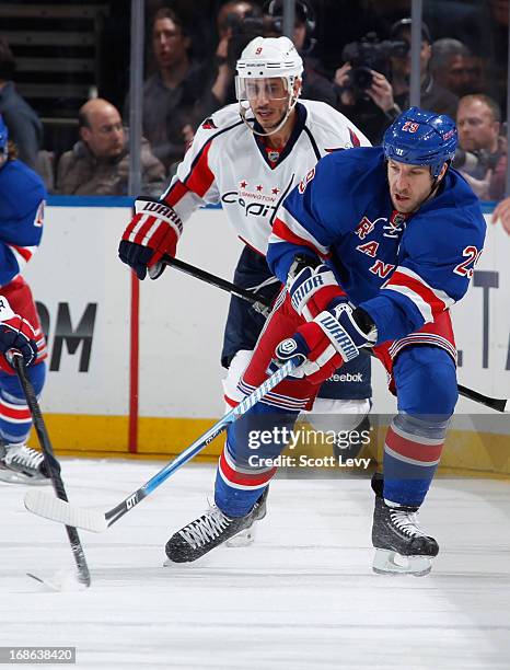 Ryane Clowe of the New York Rangers passes the puck against the Washington Capitals in Game Four of the Eastern Conference Quarterfinals during the...