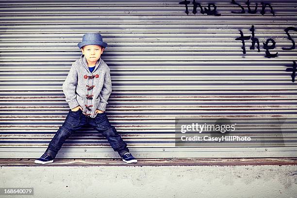 little boy on loading dock - kids fashion stockfoto's en -beelden