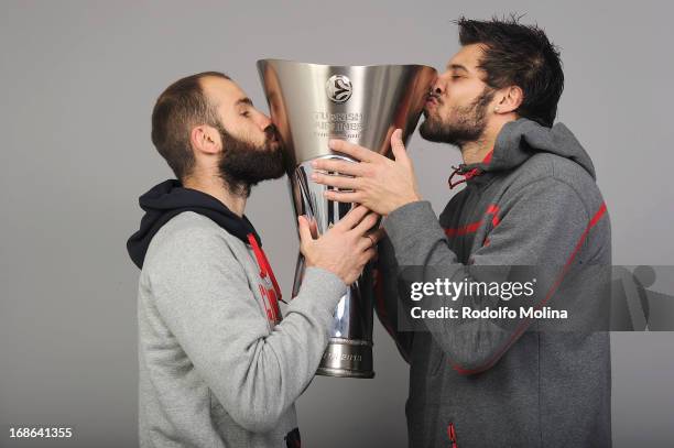 Vassilis Spanoulis and Georgios Printezis of Olympiacos Piraeus kiss the trophy during the Olympiacos Piraeus Trophy Photo Shoot at O2 Arena on May...