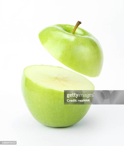 suspended apple - cutting green apple stock pictures, royalty-free photos & images