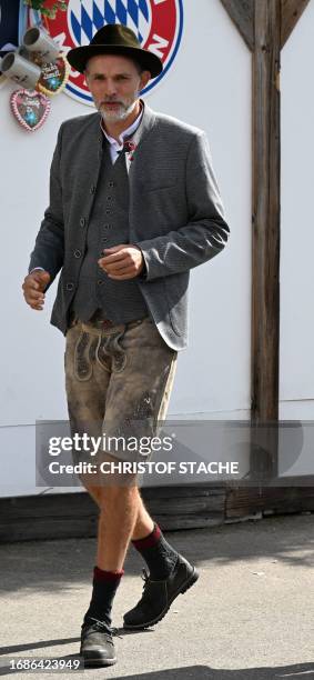 Bayern Munich's German head coach Thomas Tuchel wears a typical Bavarian dress including Lederhosen as he arrives at a festival tent as members of...