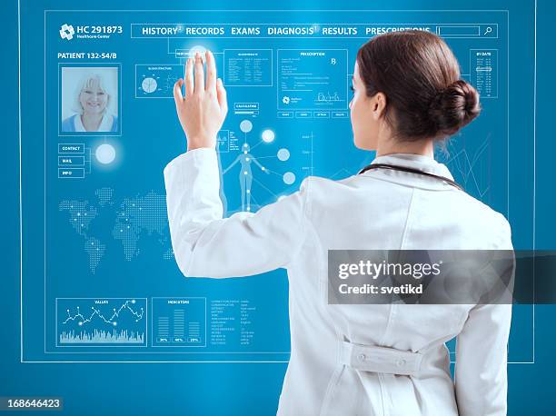 female doctor working on transparent monitor. - chemical process icon stock pictures, royalty-free photos & images