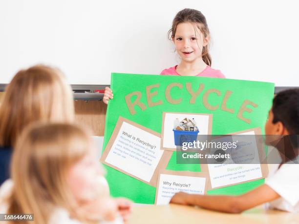 school project presentation ideas young girl giving a class presentation on recycling - school project presentation stock pictures, royalty-free photos & images