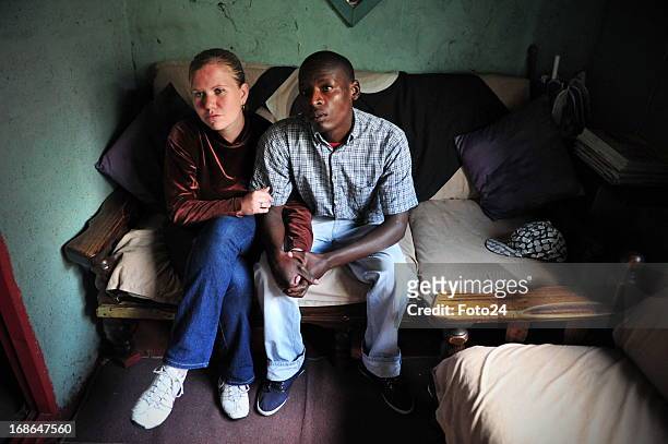 Sylvester Mmboyi with his fiance Cherene le Roux on May 9, 2013 in Alexandra township in Johannesburg, South Africa. The couple met at work started...