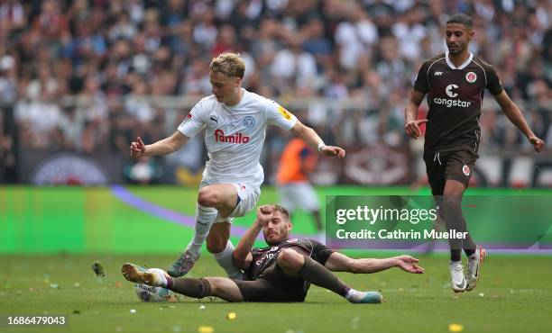 Finn Porath of Holstein Kiel is challenged by Lars Ritzka of FC St. Pauli during the Second Bundesliga match between FC St. Pauli and Holstein Kiel...