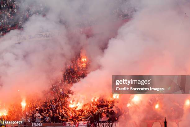 Supporters of Ajax with fireworks during the Dutch Eredivisie match between Ajax v Feyenoord at the Johan Cruijff Arena on September 24, 2023 in...