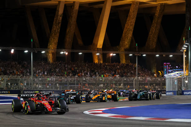F1 Grand Prix of SingaporeSINGAPORE, SINGAPORE - SEPTEMBER 17: Carlos Sainz of Spain and Ferrari drives in front of the field during the start of the Singapore Formula One Grand Prix night race at Marina Bay Street Circuit on September 17, 2023 in Singapore, Singapore. 