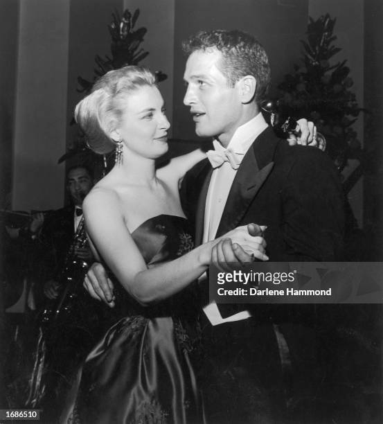 Married American actors Paul Newman and Joanne Woodward share a dance as Woodward holds her Best Actress Oscar statuette, during the Academy Awards...