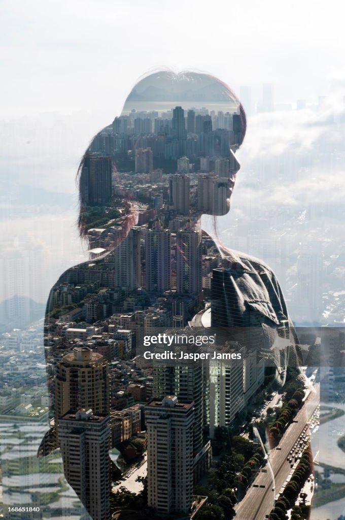 Double exposure of a young woman and cityscape