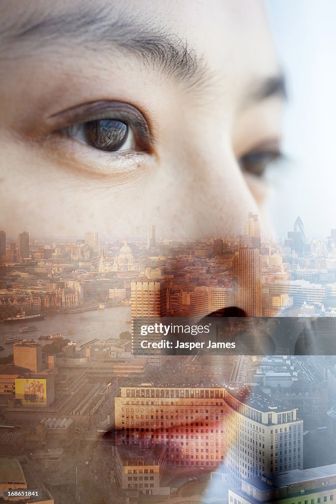Double exposure of young womans face and cityscape