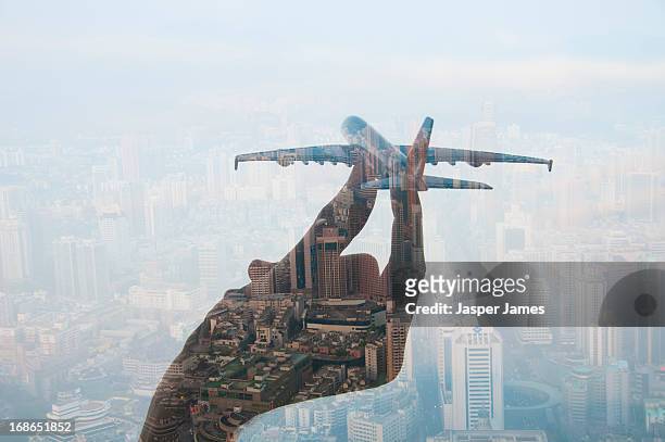 double exposure of hand holding model plane - aeroplane close up stock pictures, royalty-free photos & images