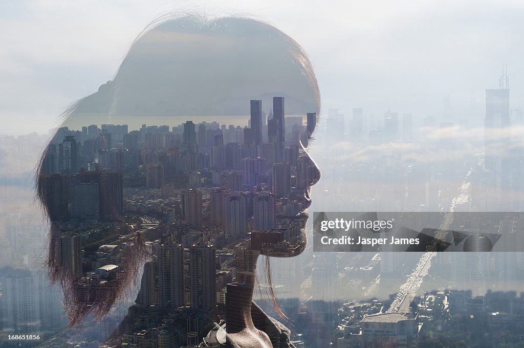 Double exposure of young woman and cityscape