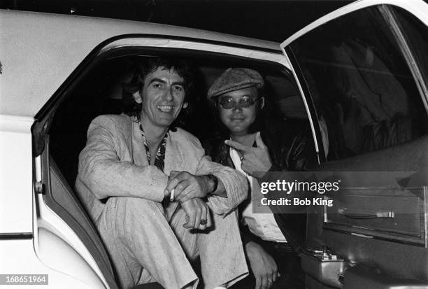 Ian Paice of Deep Purple in a limousine with George Harrison after a concert on Deep Purple's Perfect Strangers World Tour at the Entertainment...