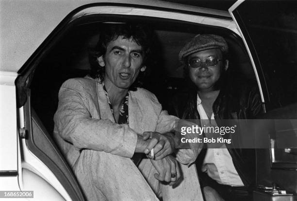 Ian Paice of Deep Purple in a limousine with George Harrison after a concert on Deep Purple's Perfect Strangers World Tour at the Entertainment...