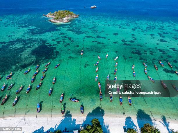aerial view of longtail boats moored on the beach in lipe islands in thailand - ko lipe stock pictures, royalty-free photos & images