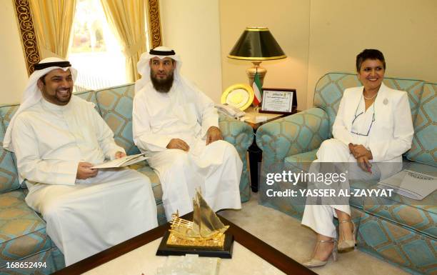 Kuwaiti MPs Safaa al-Hashem , and Yussef al-Zalzalah sit with an unidentified man after filing a request to grill Kuwaiti first Debuty Prime Minister...