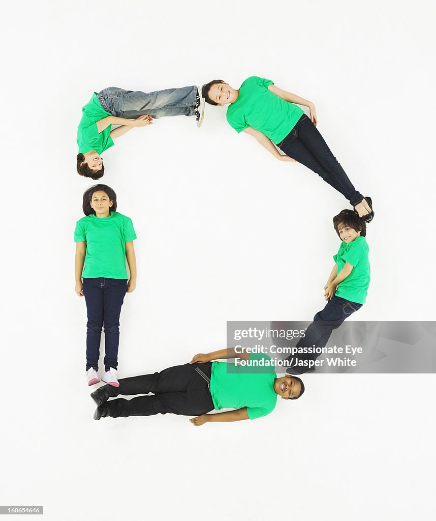 Children laying in letter 'D' formation