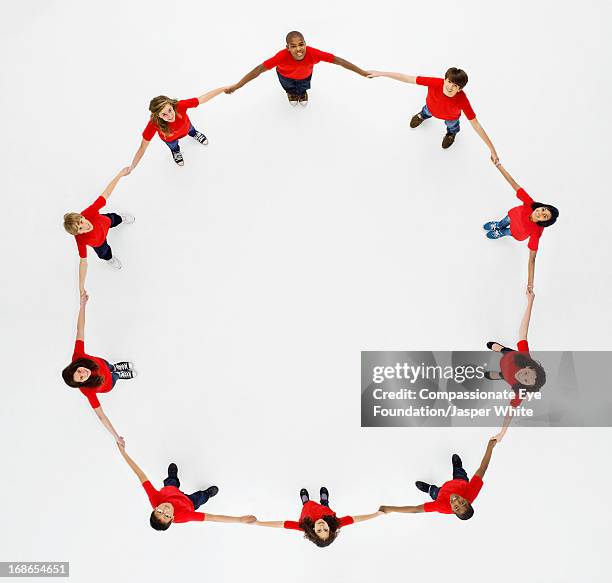 aerial view of children in a circle holding hands - hold hands circle stock pictures, royalty-free photos & images