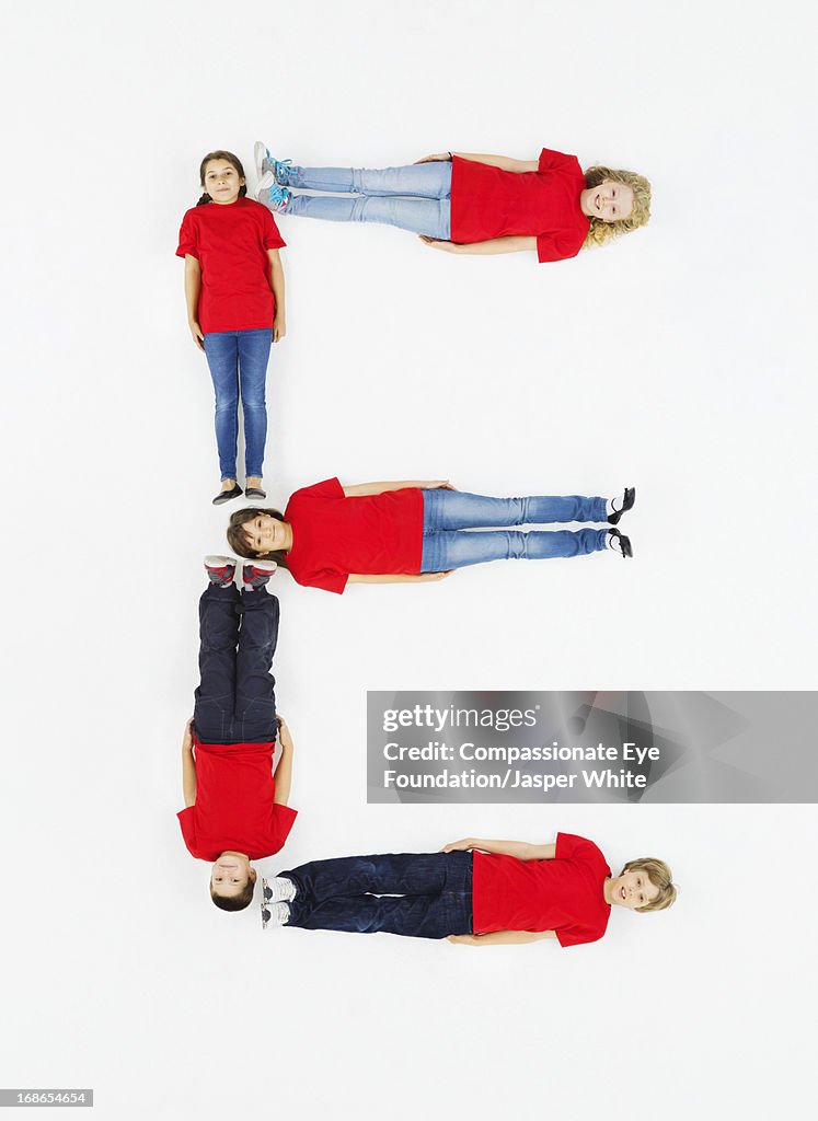 Children laying in letter 'E' formation