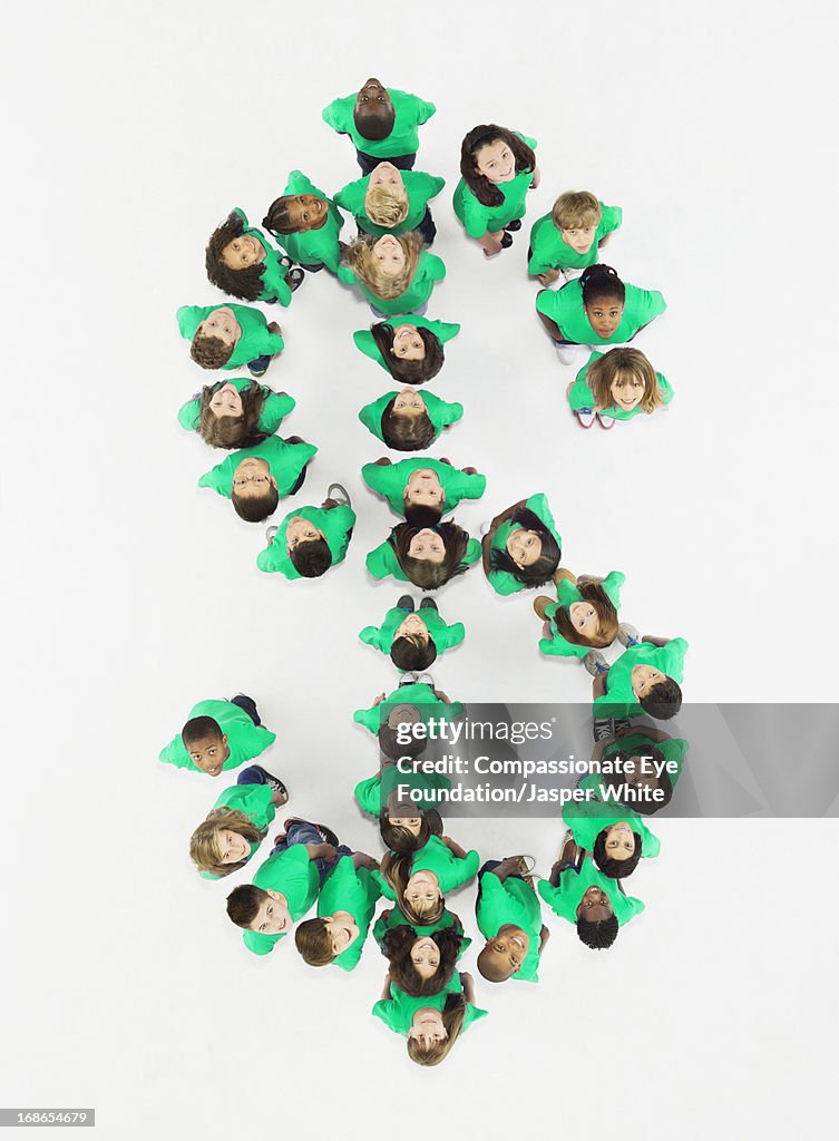 Children standing in Dollar sign formation