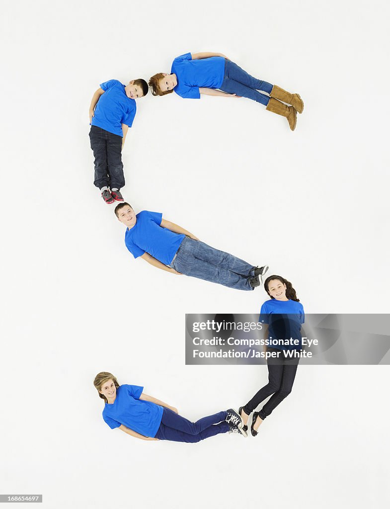 Children laying in letter 'S' formation