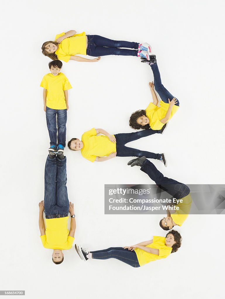 Children laying in letter 'B' formation