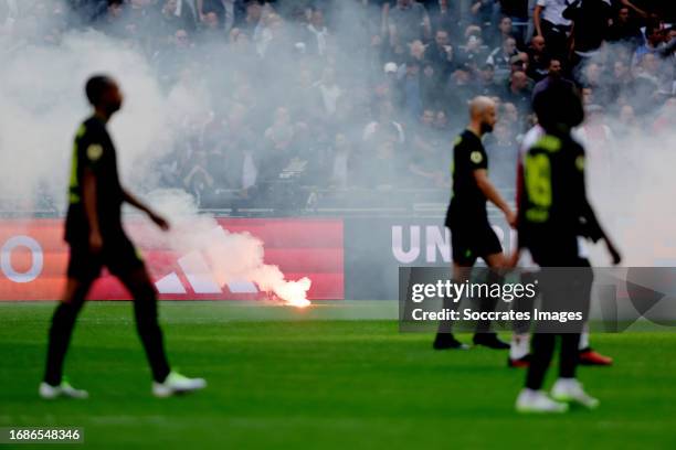 Fireworks thrown on the pitch by supporters of Ajax after the 0-3 during the Dutch Eredivisie match between Ajax v Feyenoord at the Johan Cruijff...