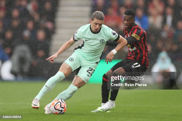 Conor Gallagher of Chelsea runs with the ball whilst under pressure from Dango Ouattara of AFC Bournemouth during the Premier League match between...
