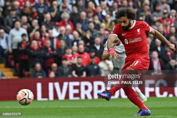 Liverpool's Egyptian striker Mohamed Salah scores the opening goal from the penalty spot during the English Premier League football match between...