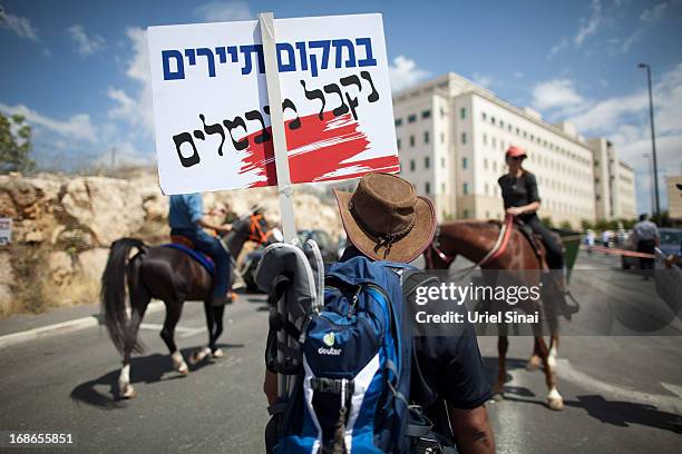 Demonstrators from the Israeli tourism industry protest against Israeli Finance Minister Yair Lapid's budget cuts outside the prime minister's office...