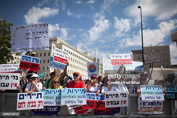 Demonstrators from the Israeli tourism industry protest against Israeli Finance Minister Yair Lapid's budget cuts outside the prime minister's office...