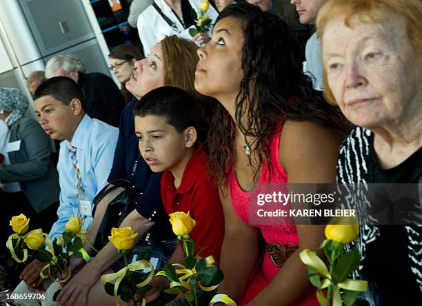 Relatives of journalist Marie Colvin, who was killed in Syria, listen at the Newseum's Journalists Memorial during the reading of names of fallen...