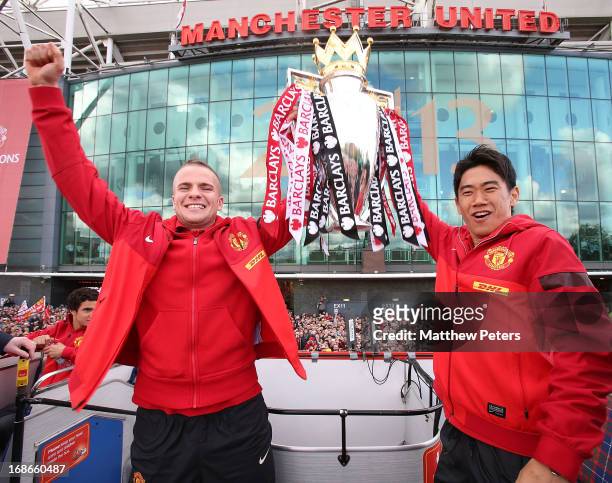 Tom Cleverley and Shinji Kagawa of Manchester United pose with the Premier League trophy at the start of the Premier League trophy winners parade on...