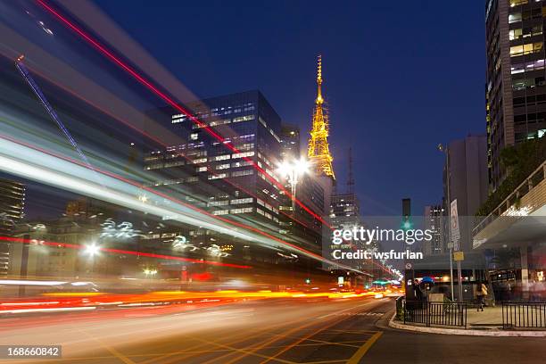 city street showing traffic flow lines with long exposure - avenida paulista stock pictures, royalty-free photos & images