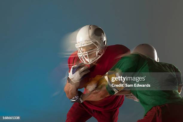 blurred view of football players with ball - rush american football stock pictures, royalty-free photos & images