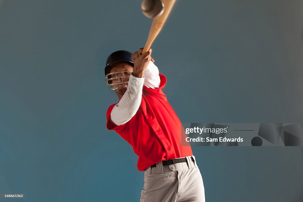 Blurred view of baseball player swinging bat