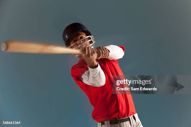 blurred view of baseball player swinging bat - at bat stockfoto's en -beelden