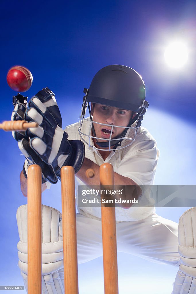 Cricket player lunging for bats
