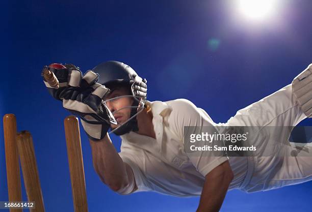 cricket player reaching for bats - cricketer bildbanksfoton och bilder