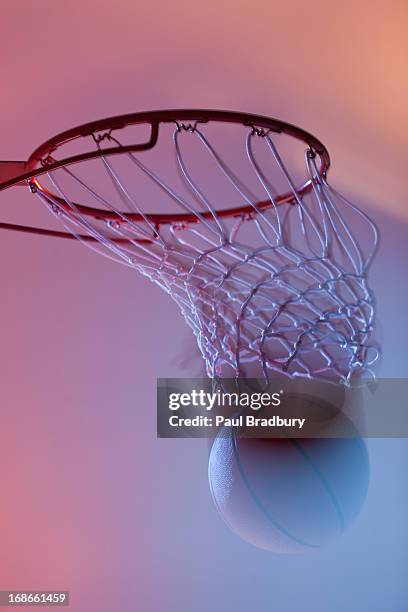 basketball on rim of hoop - basketball net stockfoto's en -beelden
