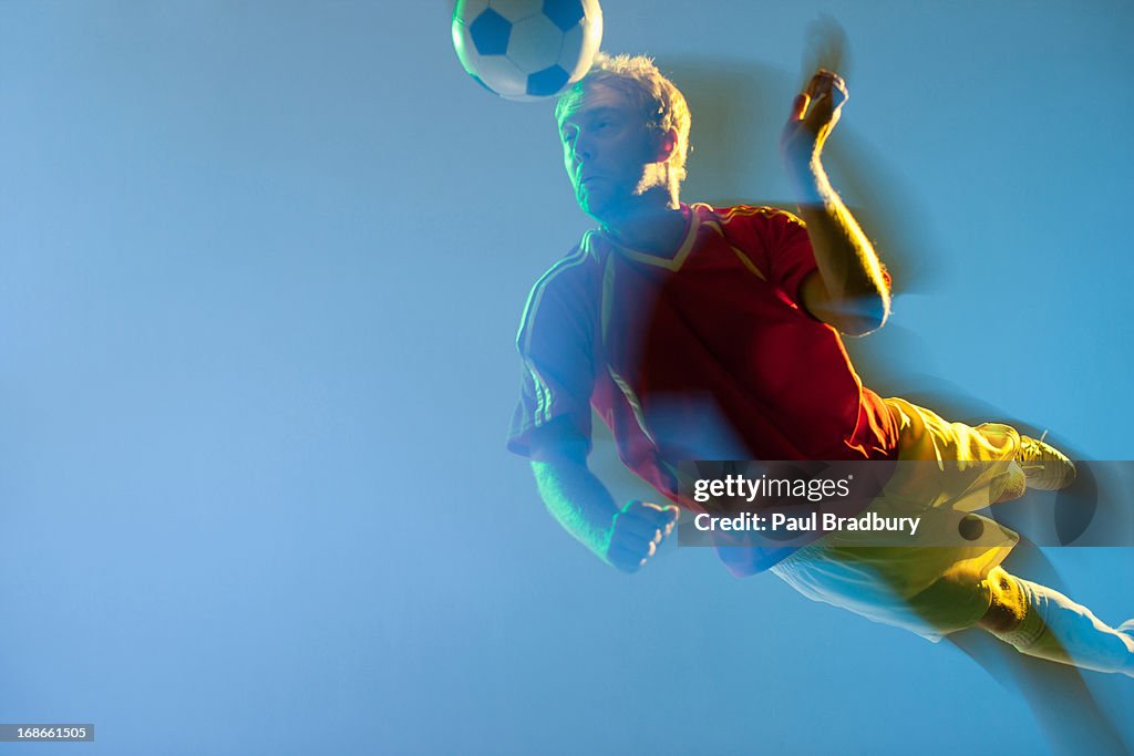 Blurred view of soccer player heading ball