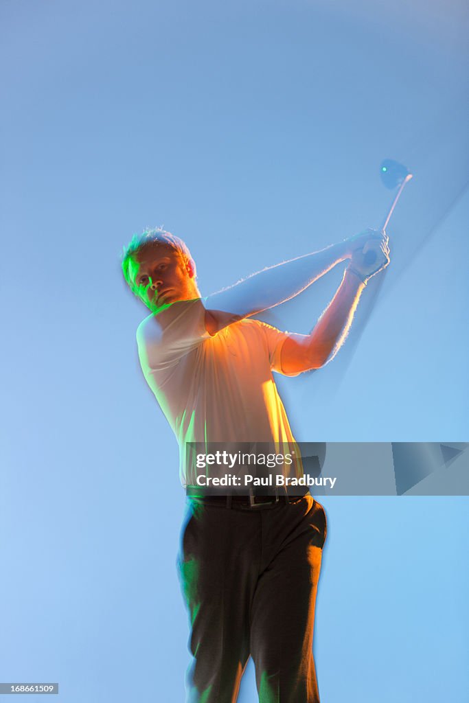 Blurred view of golf player swinging club